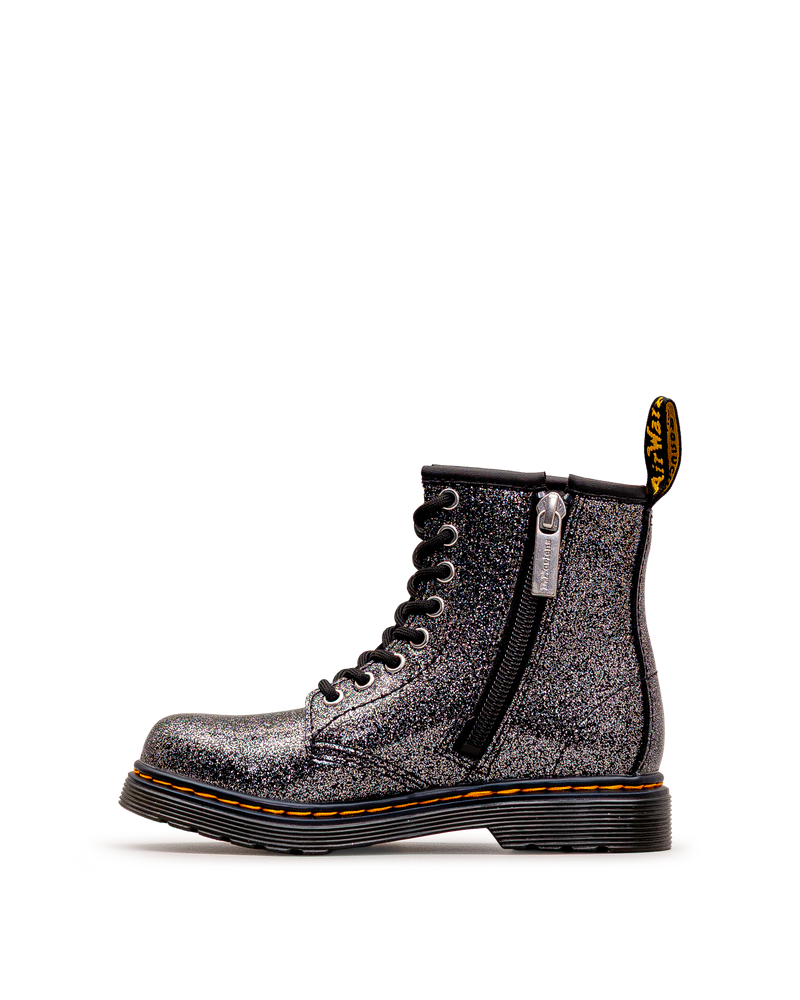 Vue latérale avec fermeture éclair des bottes Dr. Martens 1460 Glitter, noir et argent